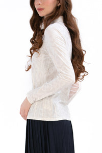 Woman wearing a White Textured Floral long-sleeve sun blocking top with a zipper, standing against a white background.