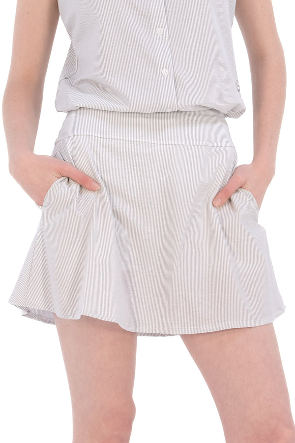 Woman wearing seersucker grey skirt