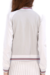 Woman wearing a Grey seersucker jacket with red accents on a white background
