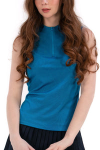 Woman wearing a Blue Opal sleeveless top and navy pleated skirt on a white background