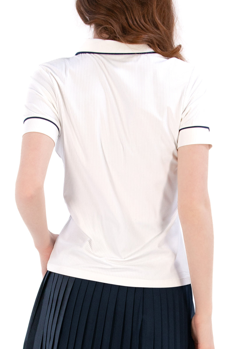 Woman wearing a white/navy top and navy skirt on a white background