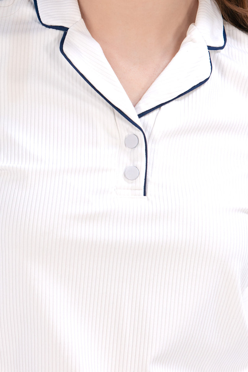 Woman wearing a white/navy top and navy skirt on a white background