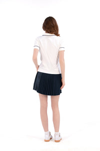 Woman wearing a white/navy top and navy skirt on a white background