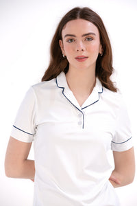 Woman wearing a white/navy top and navy skirt on a white background