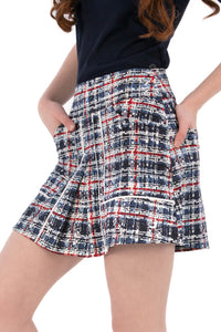 Woman wearing a navy polo shirt and plaid skirt on a white background Regular 15.5"