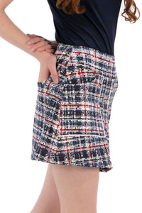 Woman wearing a navy polo shirt and plaid skirt on a white background Regular 15.5"