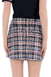 Woman wearing a navy polo shirt and plaid skirt on a white background Regular 15.5"