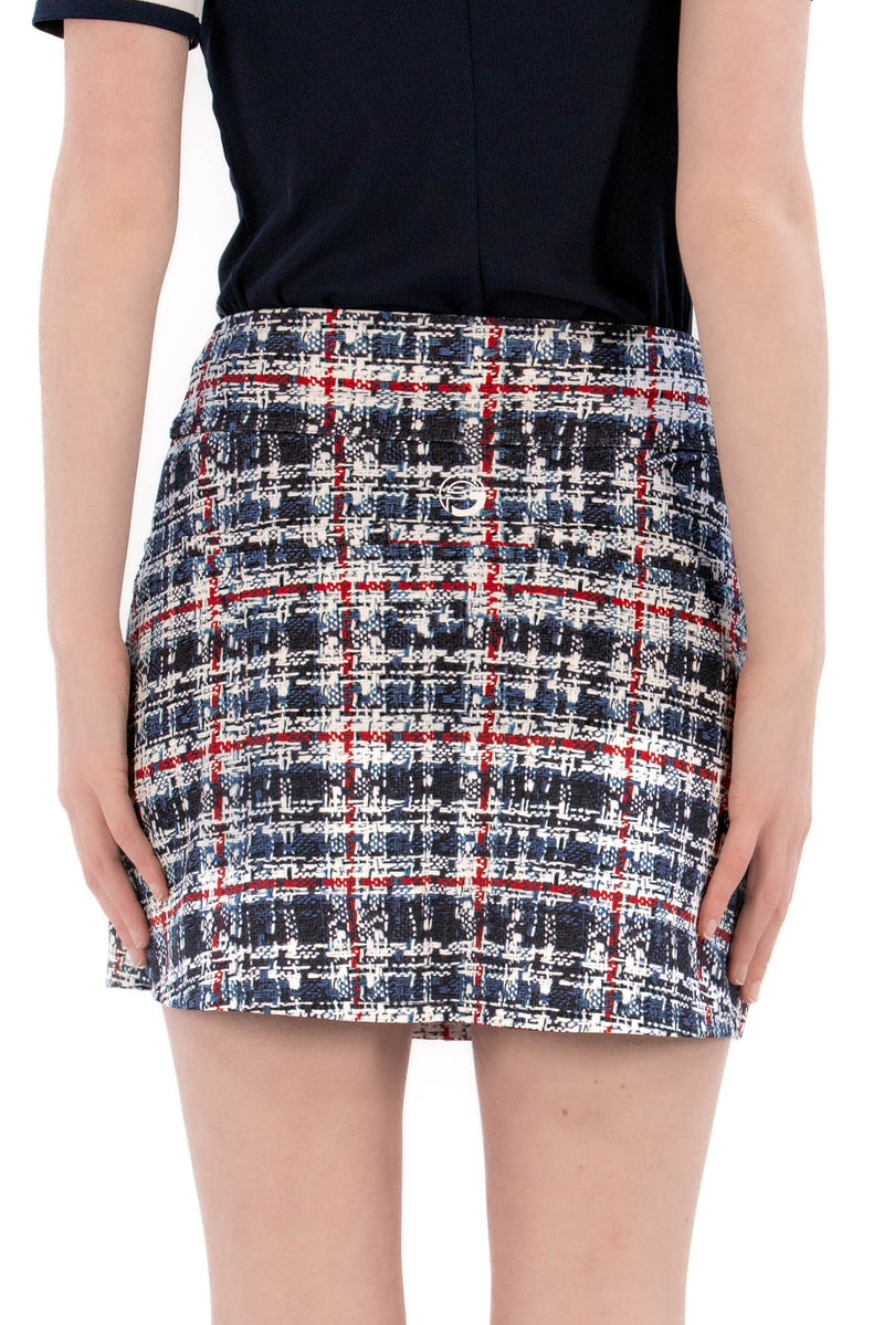 Woman wearing a navy polo shirt and plaid skirt on a white background Regular 15.5"