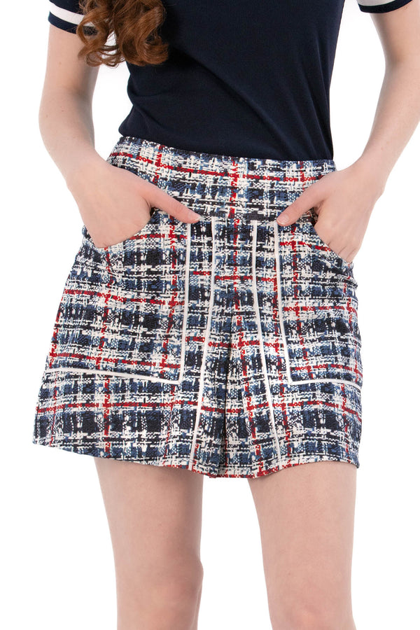 Woman wearing a navy polo shirt and plaid skirt on a white background Regular 15.5"