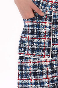 Woman wearing a navy polo shirt and plaid skirt on a white background Regular 15.5"