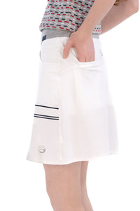 Woman in Regular 15" white skirt and knit polo.