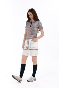 Woman in Tall 17" white skirt and knit polo.