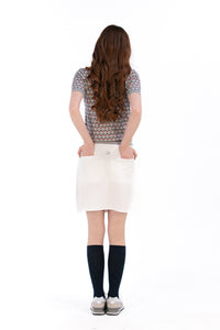 Woman in Tall 17" white skirt and knit polo.