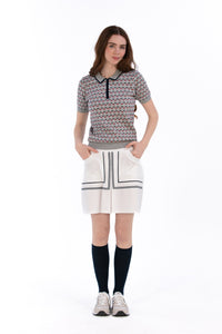 Woman in Tall 17" white skirt and knit polo.