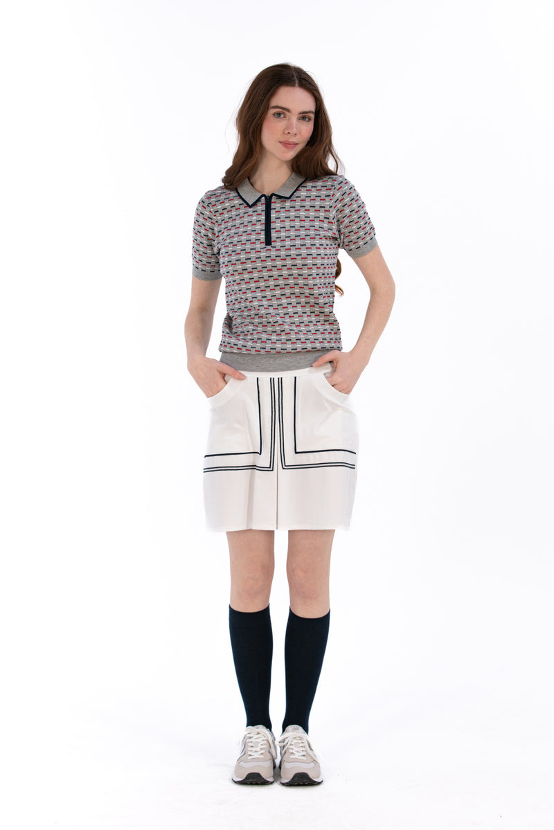 Woman in Tall 17" white skirt and knit polo.