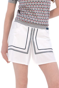 Woman in Regular 15" white skirt and knit polo.