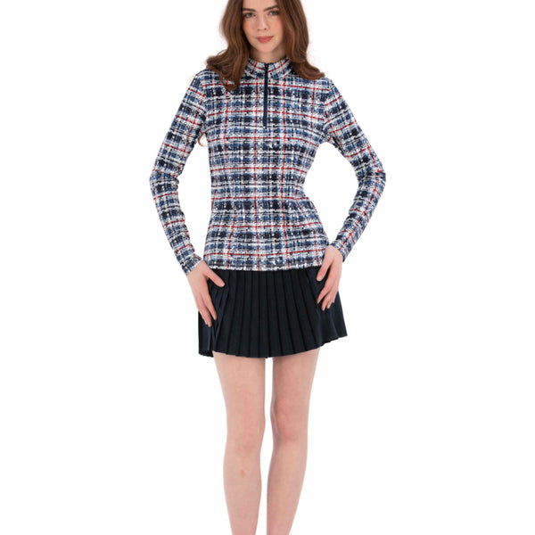 Woman wearing a Red White Blue Plaid shirt and navy pleated skirt on a white background
