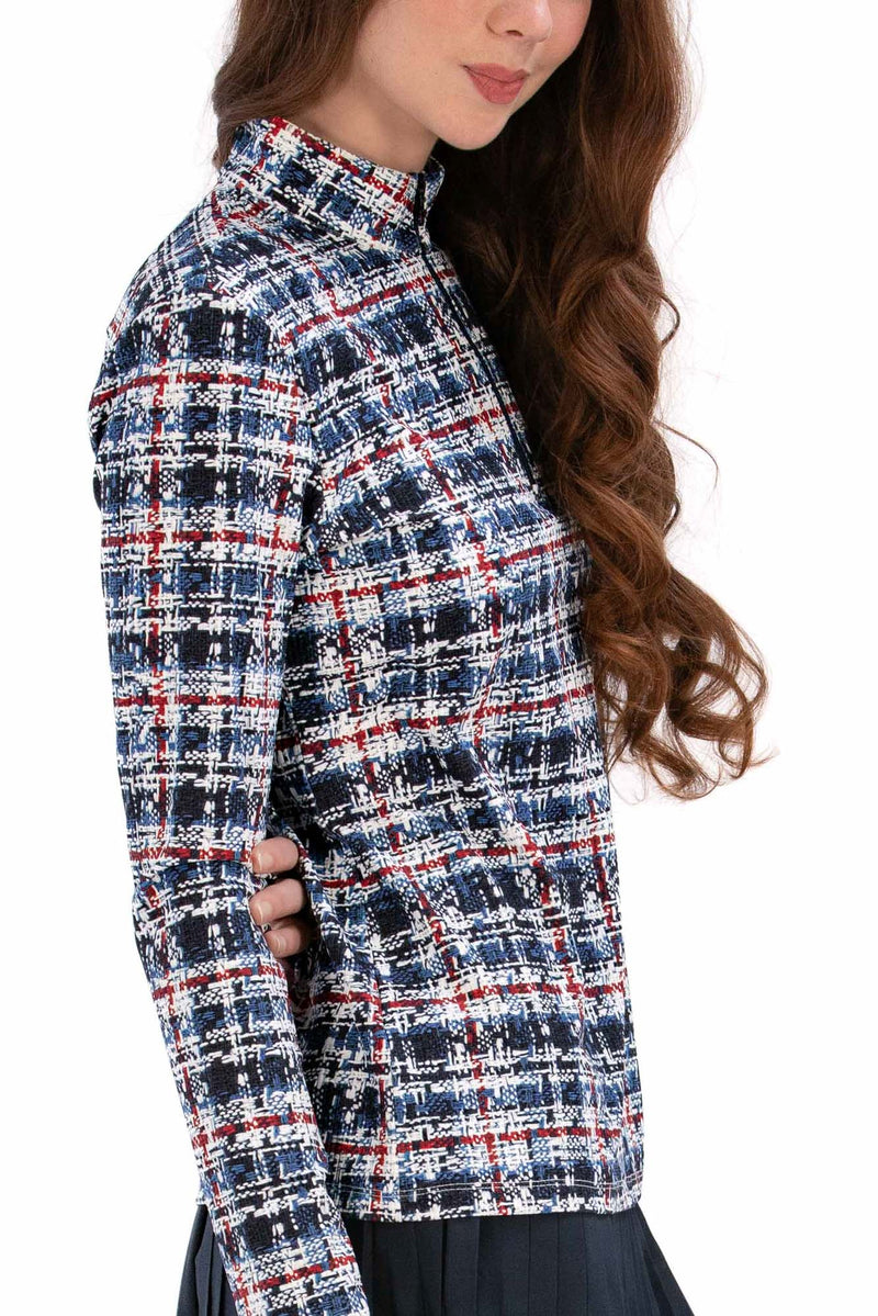 Woman wearing a Red White Blue Plaid shirt and navy pleated skirt on a white background