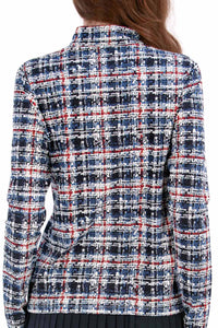 Woman wearing a Red White Blue Plaid shirt and navy pleated skirt on a white background