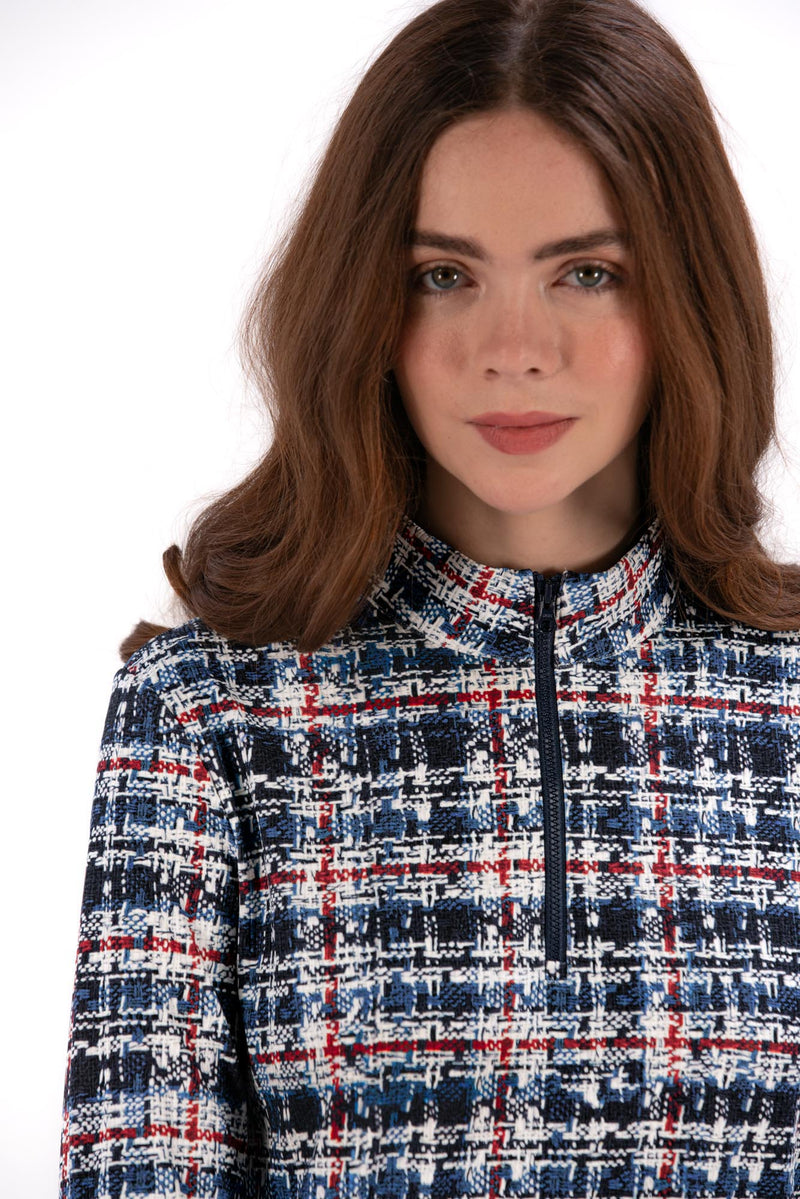 Woman wearing a Red White Blue Plaid shirt and navy pleated skirt on a white background